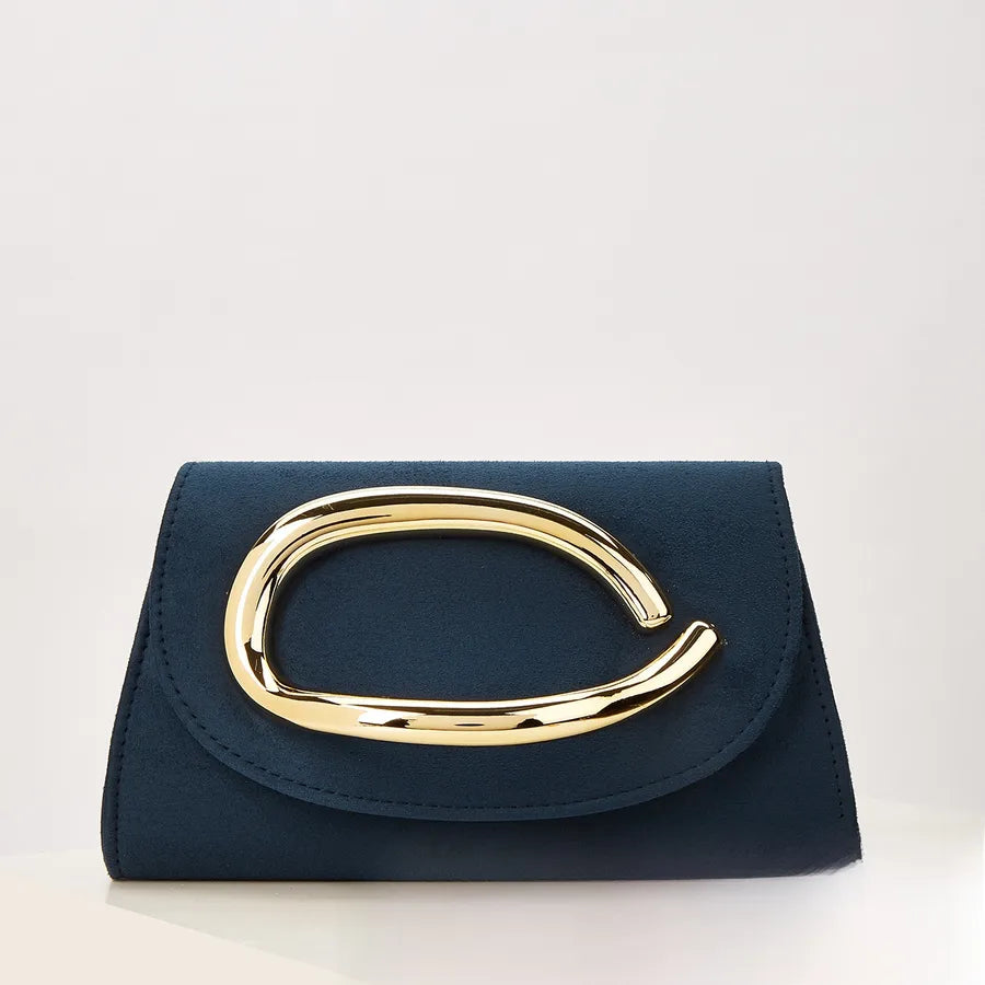 Navy clutch bag with gold handle on a light gray background