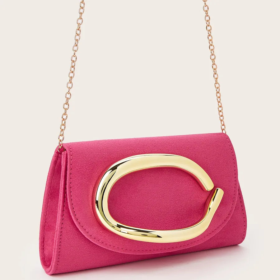 Pink clutch bag with gold clasp and chain strap on a light pink background