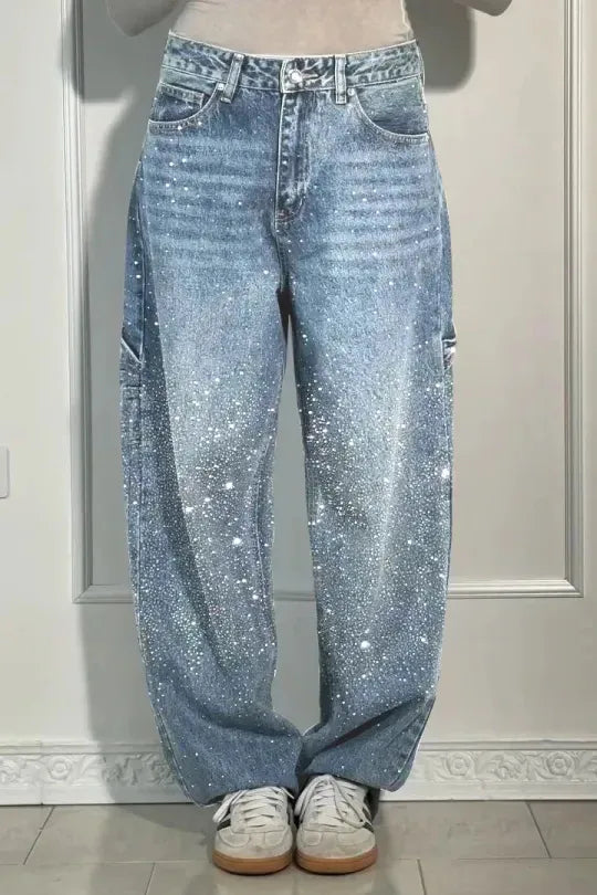 Blue jeans worn by a person on a neutral background rhinestone jeans women, sparkly jeans, crystal jeans, bling denim pants, embellished jeans, high waisted jeans women, star jeans, rhinestone denim, designer inspired jeans, glam jeans, streetwear jeans women, trendy denim pants, fashion jeans women, statement jeans, luxury denim, straight leg jeans, commuter style fashion, women's denim pants, sparkle jeans, casual glam outfit