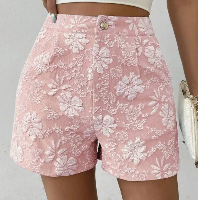 Pink floral shorts worn by a person against a neutral background high waisted shorts women, jacquard shorts, vintage shorts women, boho shorts, summer shorts women, boutique shorts, woven shorts women, resort wear women, vacation outfit women, chic summer shorts, elegant shorts women, festival outfit women, high rise shorts, trendy summer fashion, casual chic outfit, bohemian shorts, statement shorts women, women's fashion shorts, luxury summer style, boutique clothing women