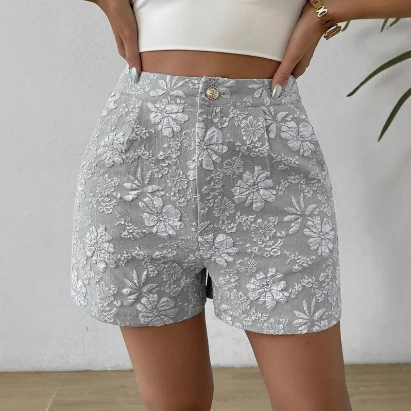 Gray floral shorts worn by a person against a plain background high waisted shorts women, jacquard shorts, vintage shorts women, boho shorts, summer shorts women, boutique shorts, woven shorts women, resort wear women, vacation outfit women, chic summer shorts, elegant shorts women, festival outfit women, high rise shorts, trendy summer fashion, casual chic outfit, bohemian shorts, statement shorts women, women's fashion shorts, luxury summer style, boutique clothing women