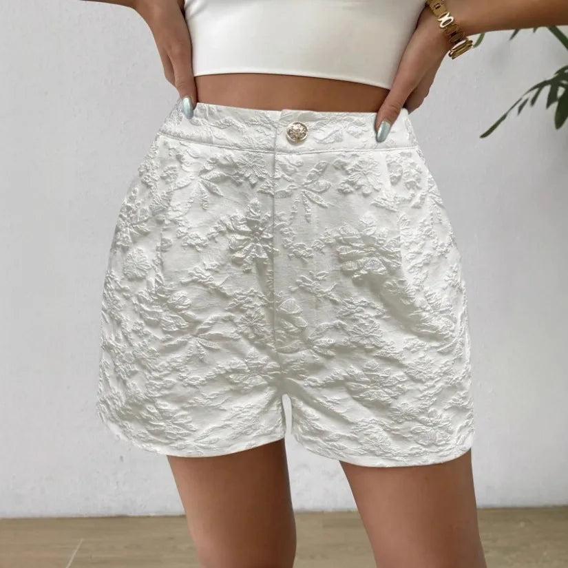 White textured shorts worn by a person against a plain background high waisted shorts women, jacquard shorts, vintage shorts women, boho shorts, summer shorts women, boutique shorts, woven shorts women, resort wear women, vacation outfit women, chic summer shorts, elegant shorts women, festival outfit women, high rise shorts, trendy summer fashion, casual chic outfit, bohemian shorts, statement shorts women, women's fashion shorts, luxury summer style, boutique clothing women