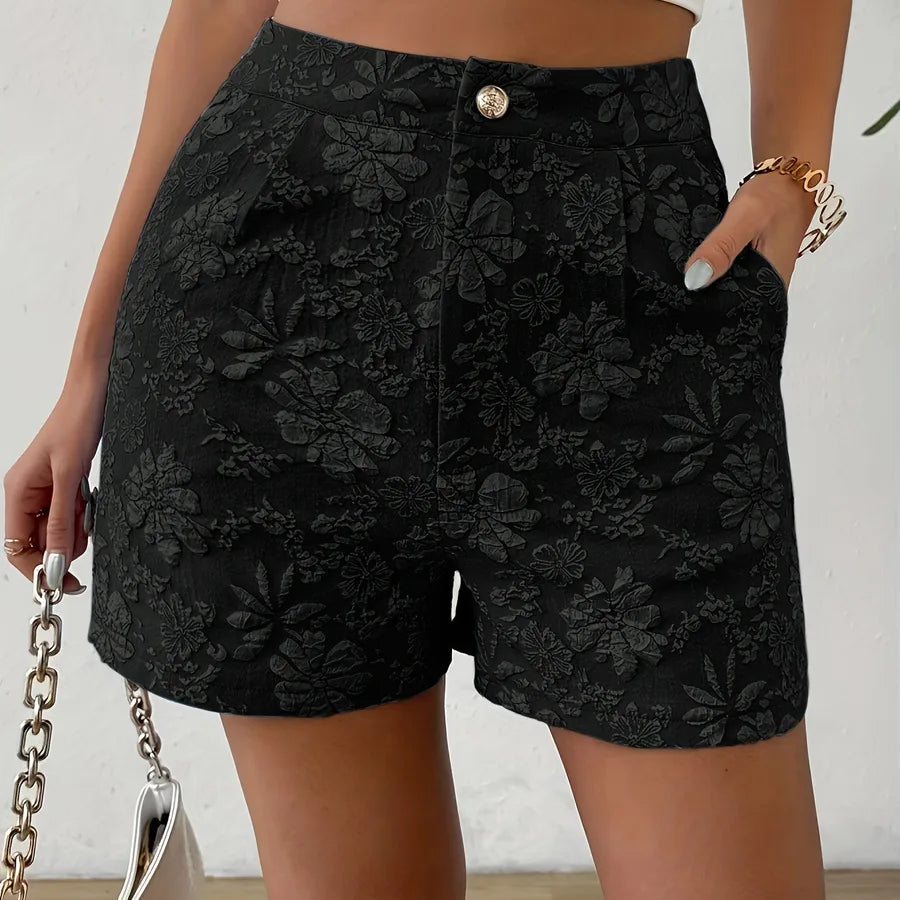 Black floral shorts worn by a person against a neutral background high waisted shorts women, jacquard shorts, vintage shorts women, boho shorts, summer shorts women, boutique shorts, woven shorts women, resort wear women, vacation outfit women, chic summer shorts, elegant shorts women, festival outfit women, high rise shorts, trendy summer fashion, casual chic outfit, bohemian shorts, statement shorts women, women's fashion shorts, luxury summer style, boutique clothing women