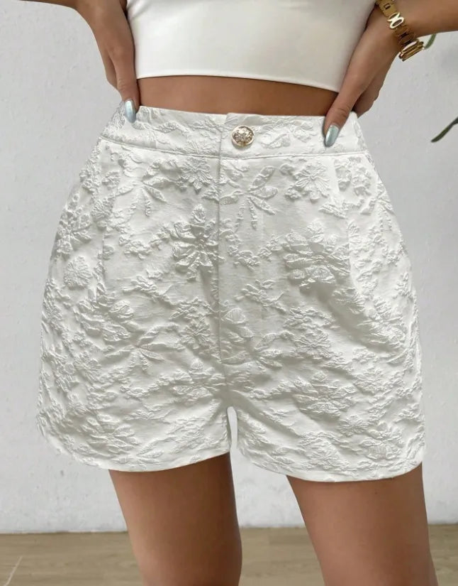 White textured shorts worn by a person against a plain background high waisted shorts women, jacquard shorts, vintage shorts women, boho shorts, summer shorts women, boutique shorts, woven shorts women, resort wear women, vacation outfit women, chic summer shorts, elegant shorts women, festival outfit women, high rise shorts, trendy summer fashion, casual chic outfit, bohemian shorts, statement shorts women, women's fashion shorts, luxury summer style, boutique clothing women