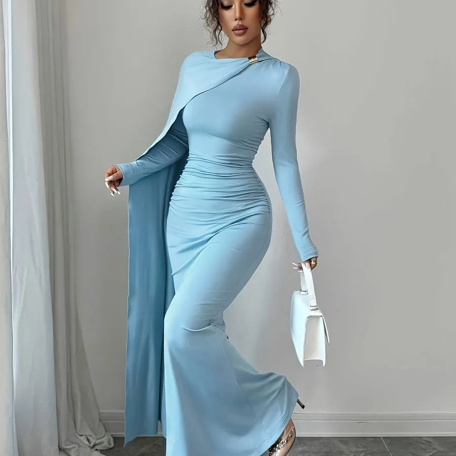 Woman wearing a light blue dress with a long train against a gray background