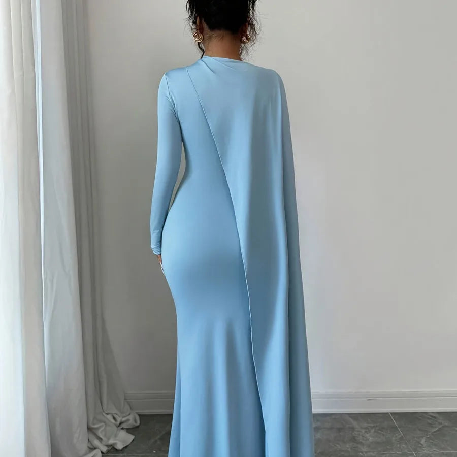 Light blue evening gown with a slit on a plain background