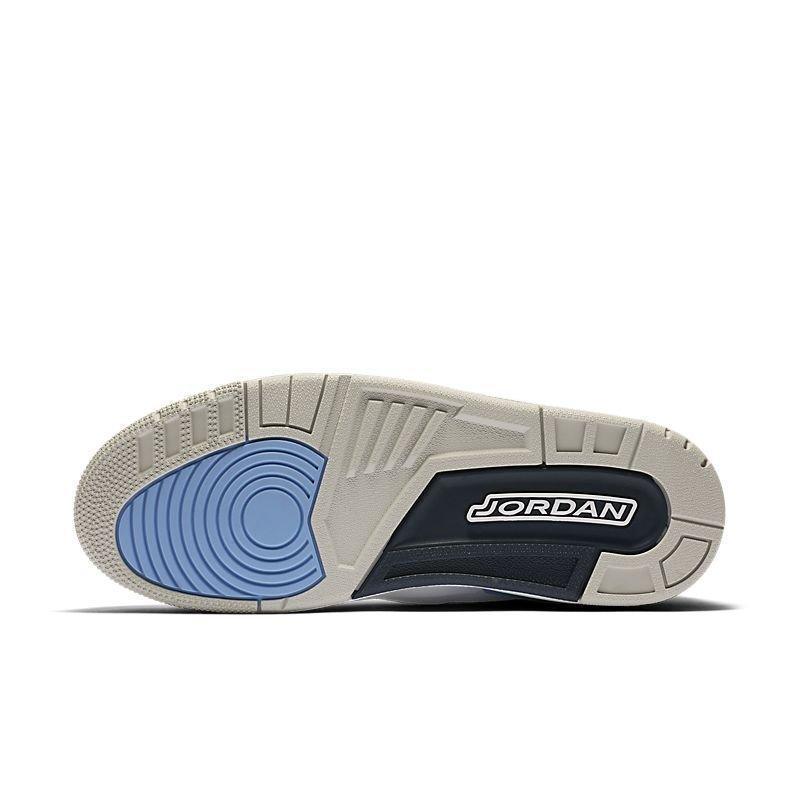 The outsole of a Jordan sneaker, featuring a light beige and gray midsole with a blue circular tread pattern on the heel and a black heel section with the white 'JORDAN' logo. Air Jordan 3 Retro 'UNC'