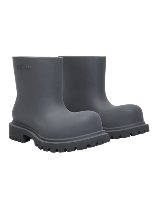 Balenciaga Steroid slip-on rubber boots in gray featuring an exaggerated round toe, embossed side logo, and a durable lug sole.