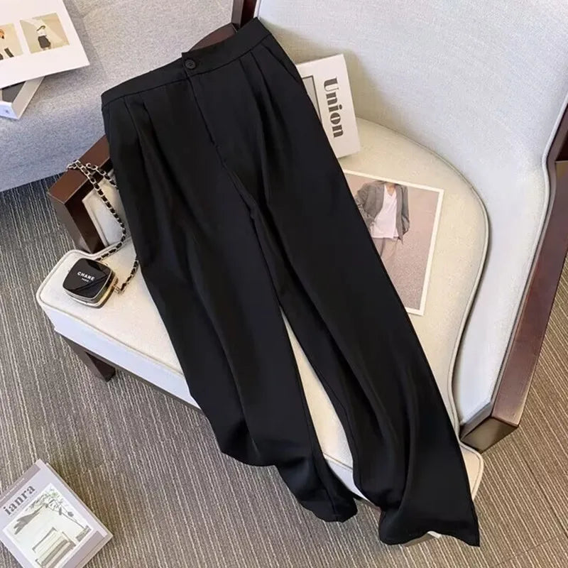 Black pants on a chair with a small bag and magazines in the background