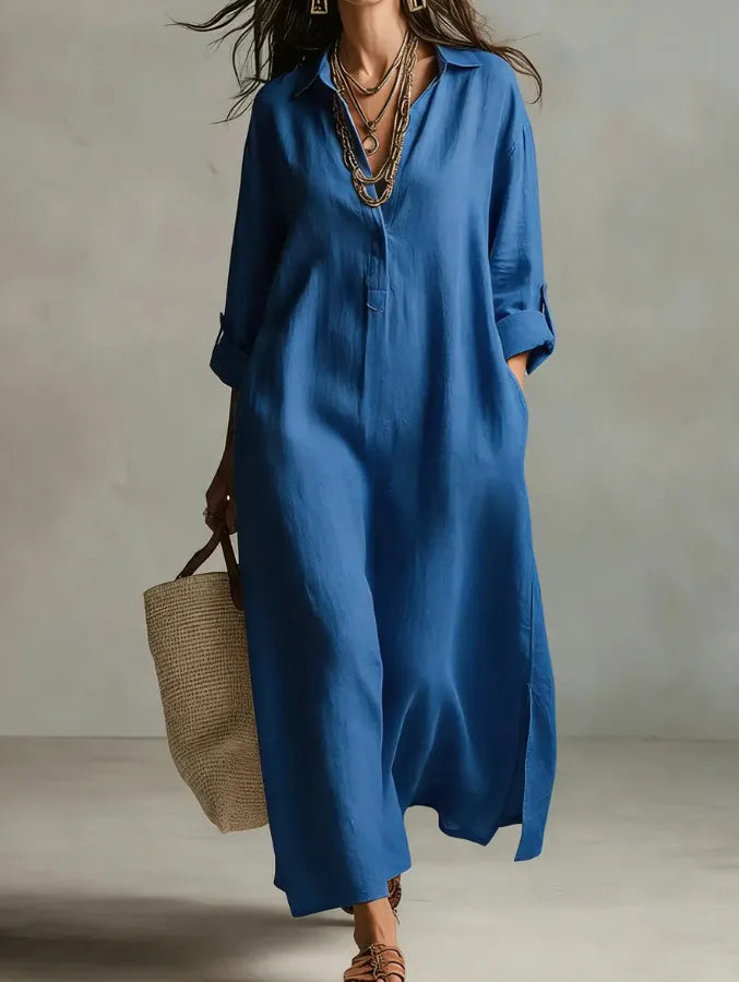 Woman wearing a blue dress holding a woven bag against a neutral background