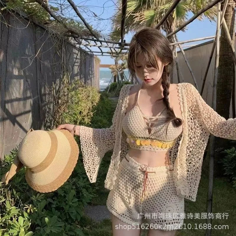 Woman in a light outfit holding a straw hat in an outdoor setting