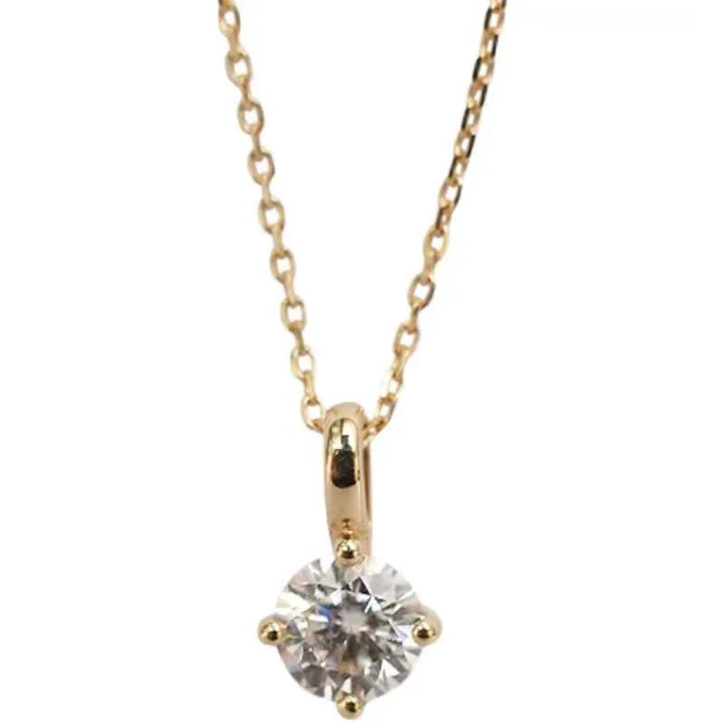 Gold necklace with a diamond pendant on a white background