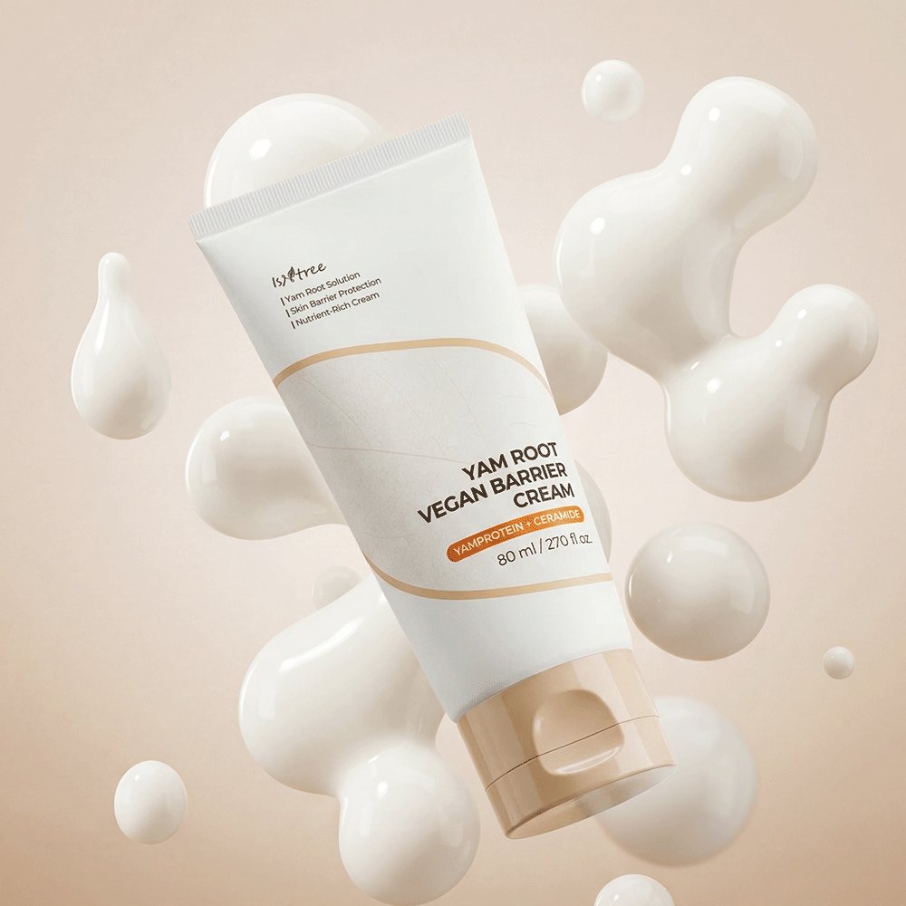A white cosmetic tube labeled 'innree YAM ROOT VEGAN BARRIER CREAM' floating among glossy white droplet shapes on a soft beige background.