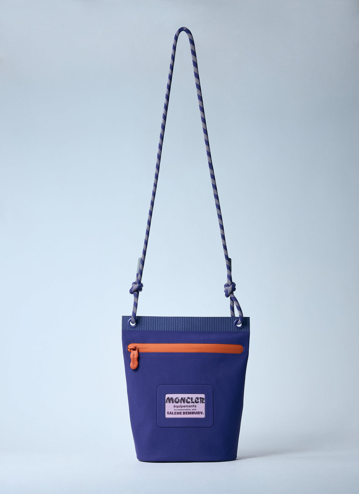 Blue bag with orange zipper and visible brand logo on a light gray background