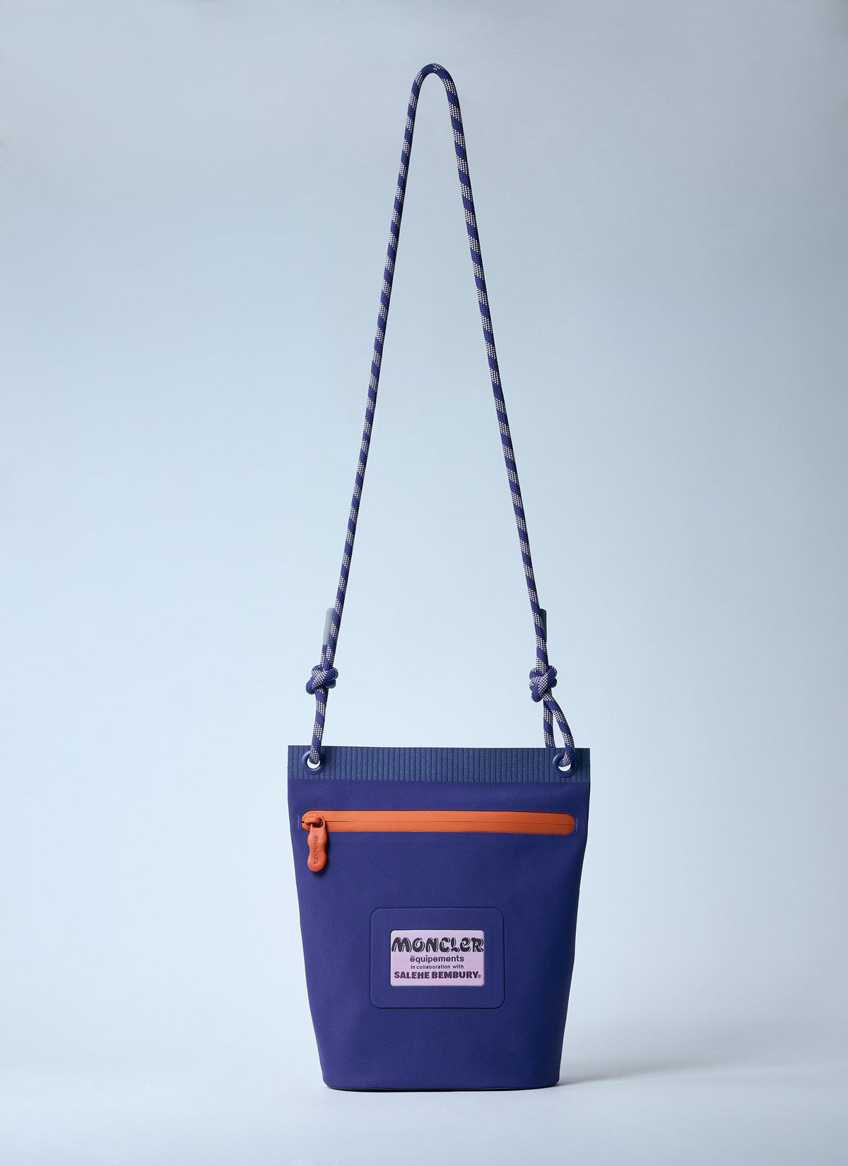 Blue bag with orange zipper and visible brand logo on a light gray background