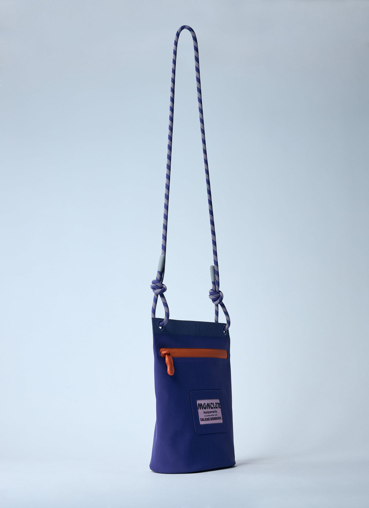 Navy blue pouch with an orange zipper on a light gray background