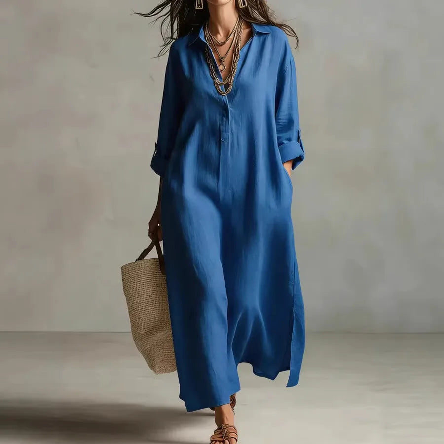 Woman wearing a blue dress holding a woven bag against a neutral background