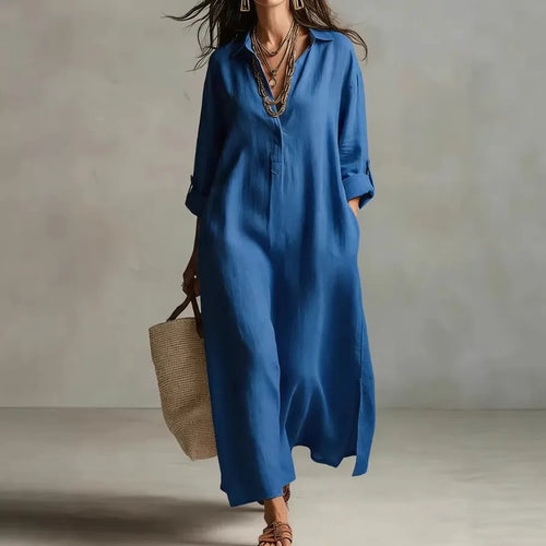 Woman wearing a blue dress holding a woven bag against a neutral background