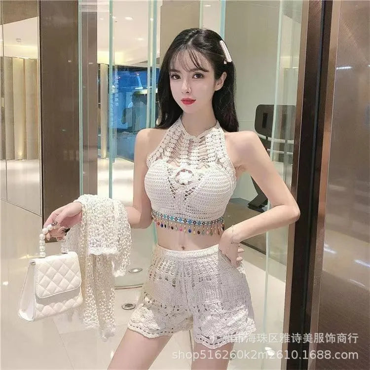 Woman in a white outfit holding a handbag in an indoor setting
