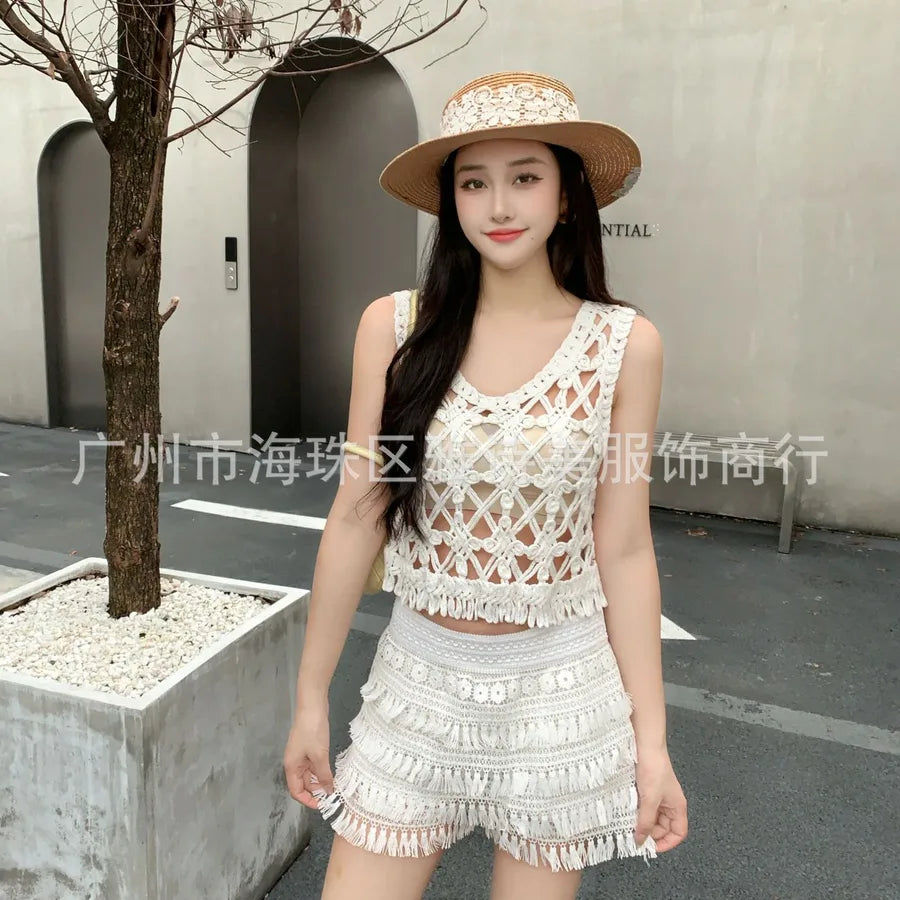 Woman wearing a white crochet outfit and hat in an urban setting