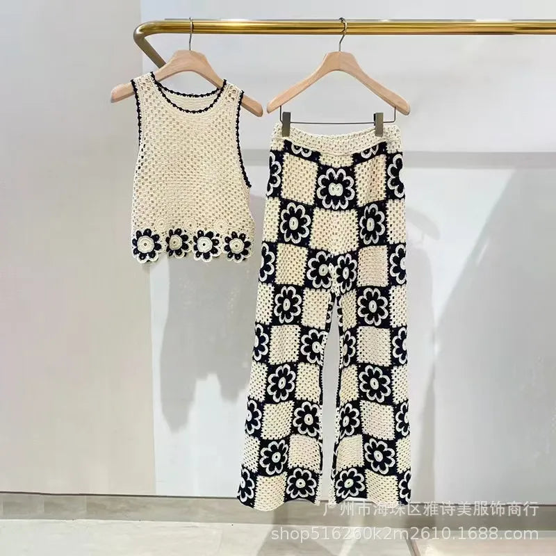 Black and white floral patterned outfit on hangers against a white background