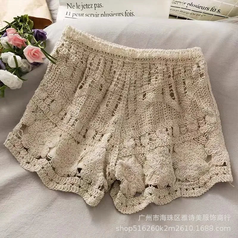 Beige lace shorts on a light background with flowers and text.