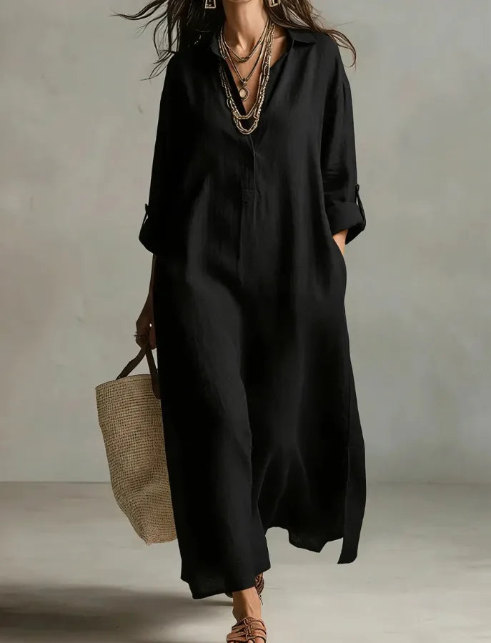 Person wearing a black dress holding a woven bag against a neutral background