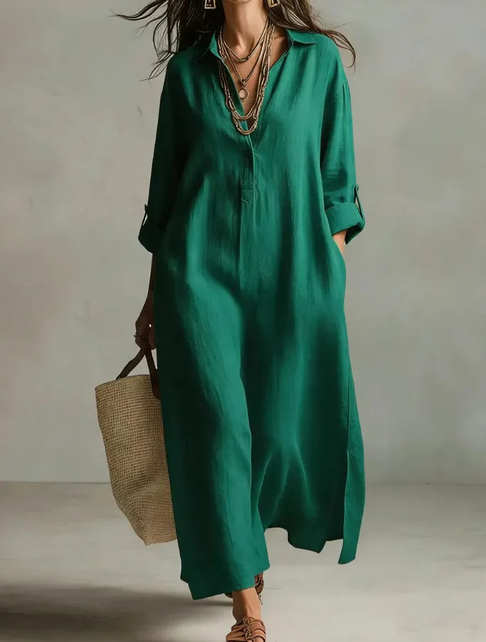 Woman wearing a green dress holding a woven bag against a neutral background