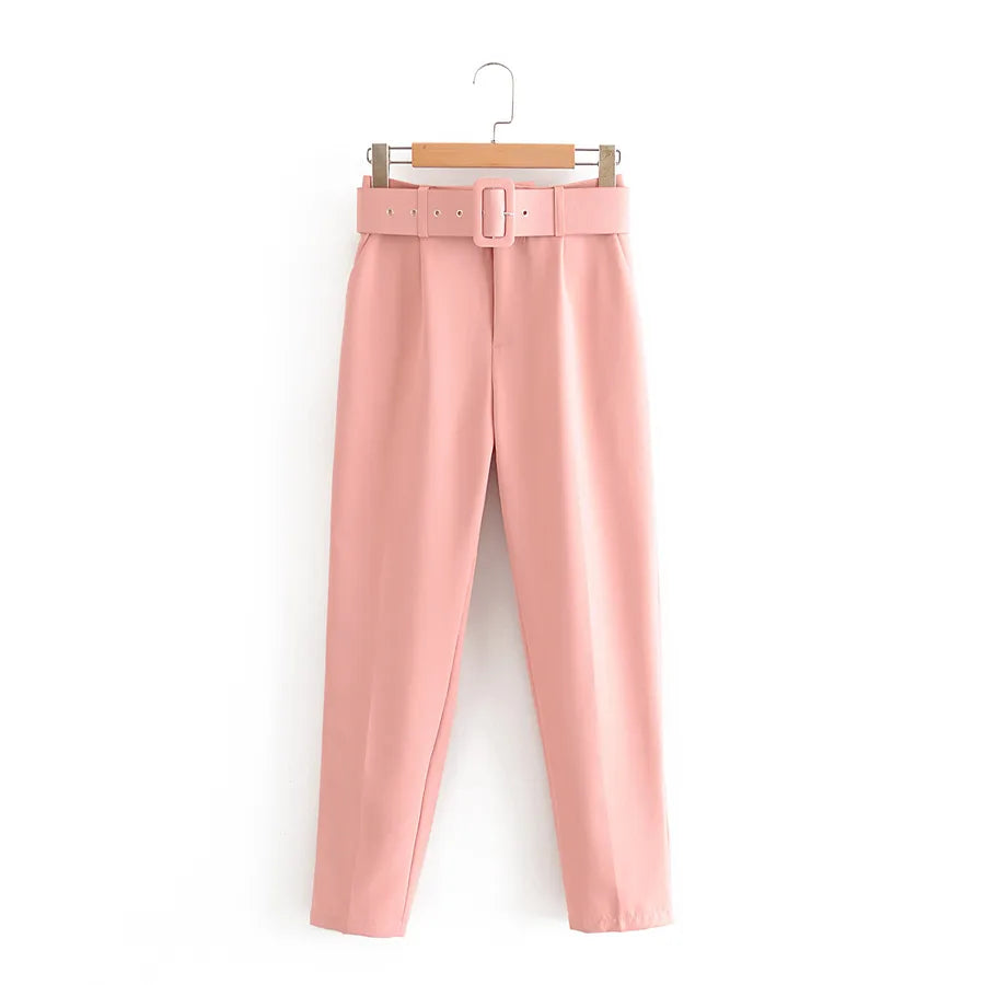 Pink pants with a belt on a hanger against a white background