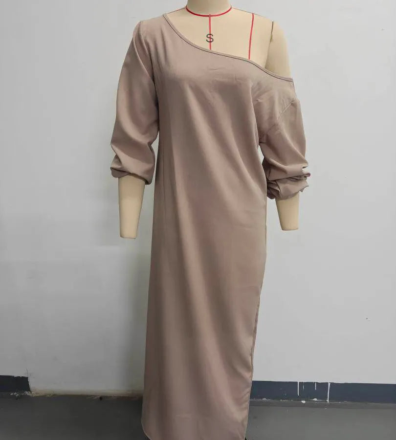 Beige dress on a mannequin against a plain background