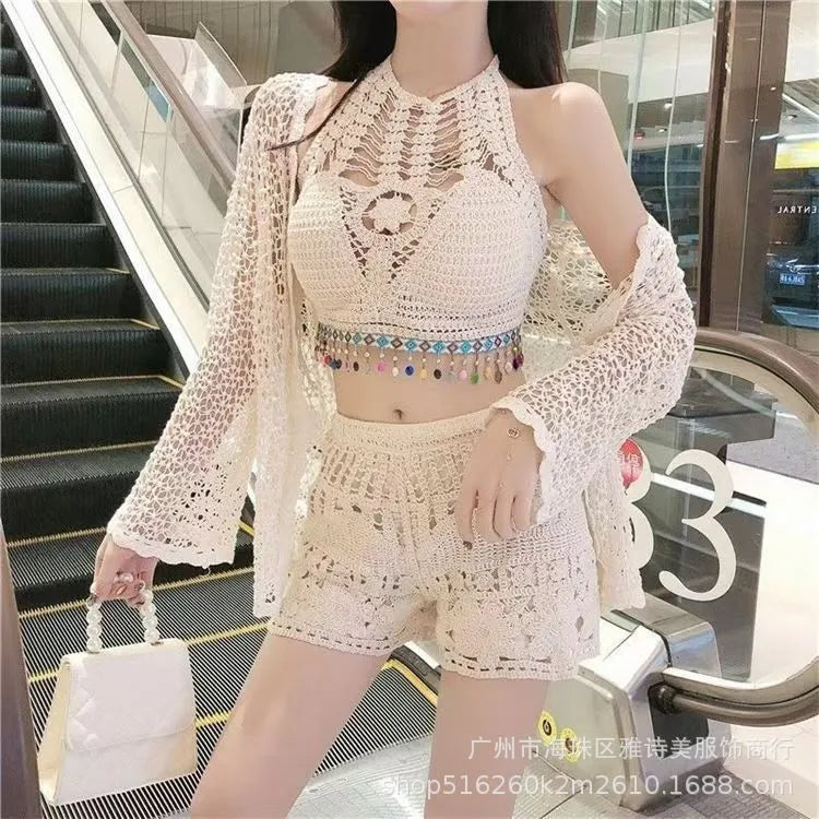 Person wearing a crochet outfit with a white handbag in an indoor setting