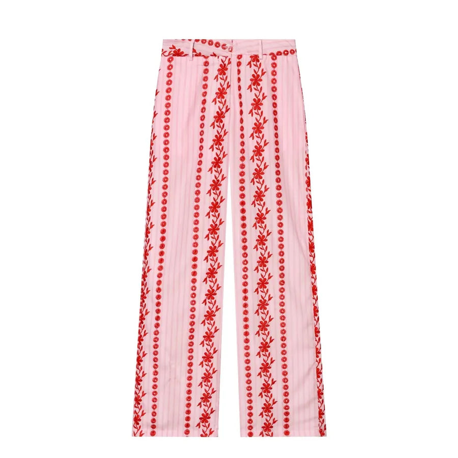 Pink pants with red floral embroidery on a white background pink pants with red flowers