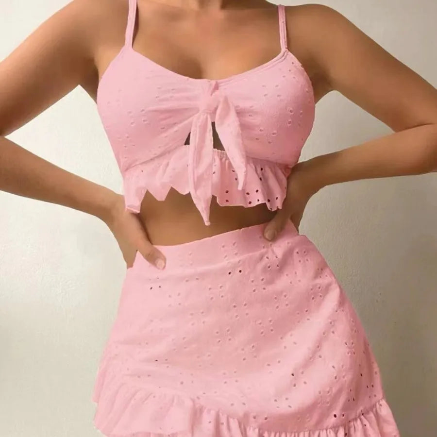 Pink eyelet top and skirt set on a neutral background