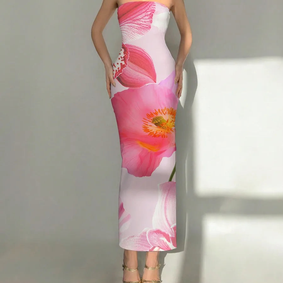 Woman wearing a floral dress with pink flowers against a neutral background. Vacation resort dress
