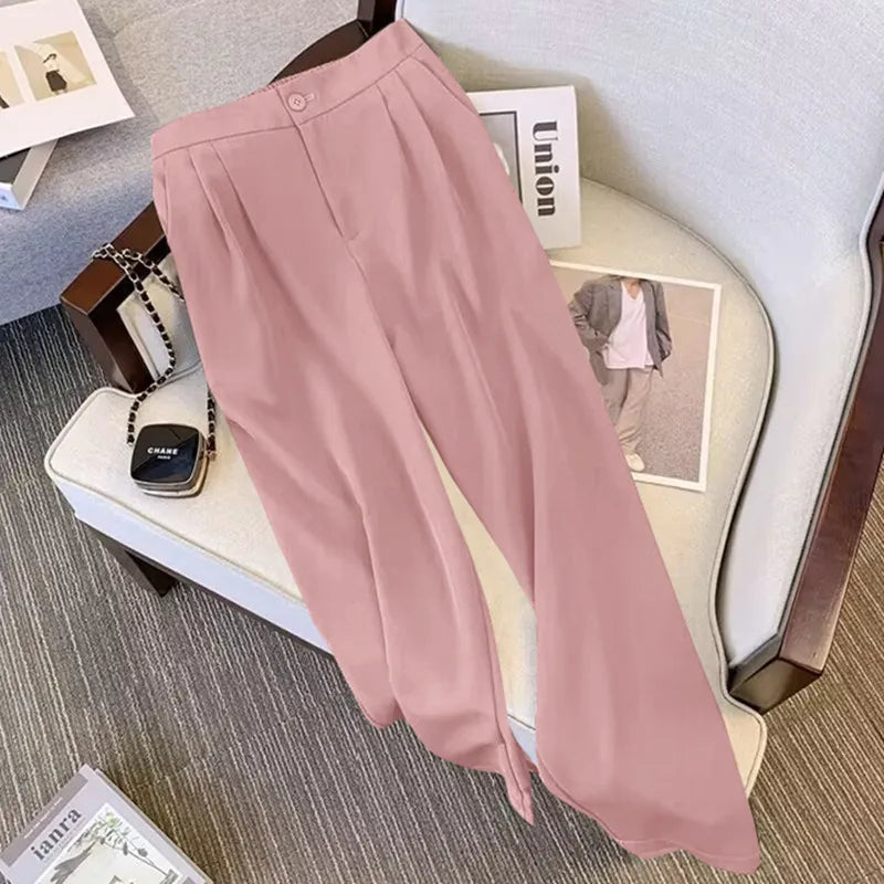 Pink pants on a chair with a magazine and handbag in the background