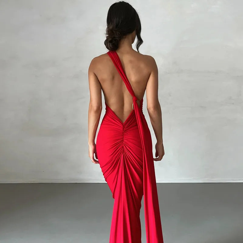 Woman wearing a red one-shoulder dress with a plain background