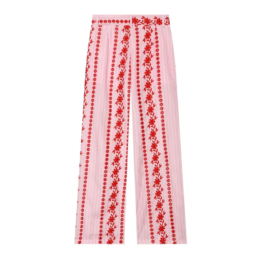 Pink pants with red floral embroidery on a white background pink pants with red flowers