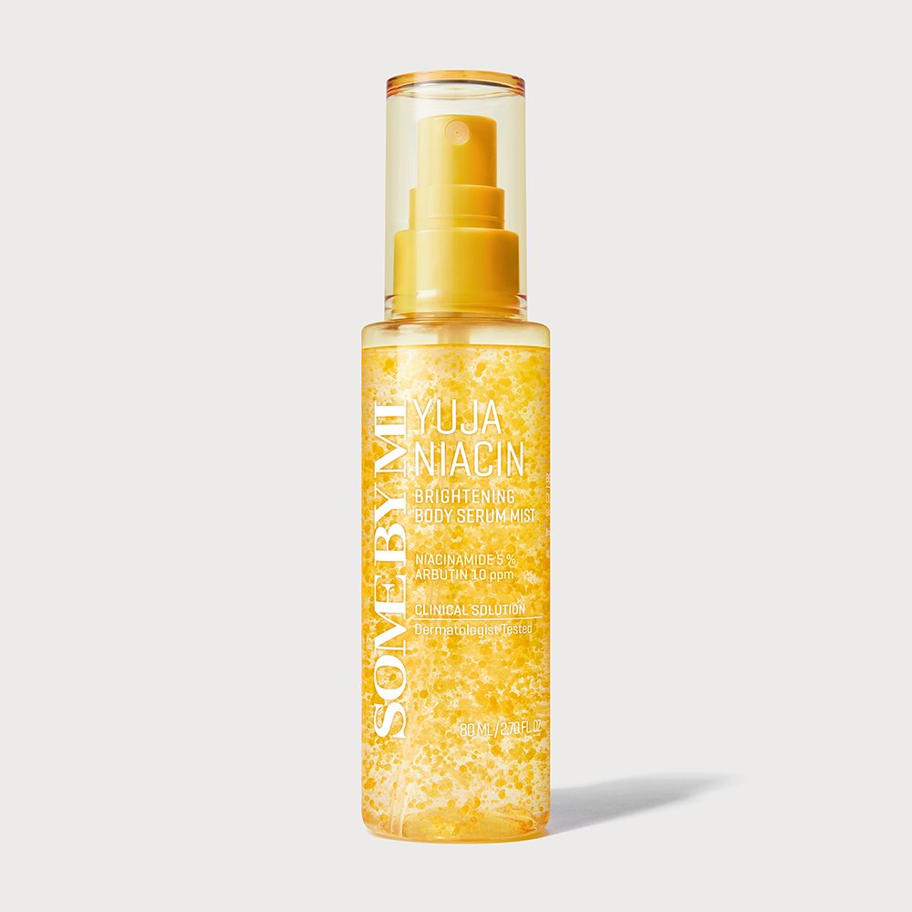 A bottle of Som by Mi Yuja Niacin Brightening Skin Serum, featuring a clear bottle filled with golden-yellow sparkling liquid and a matching yellow pump dispenser, set against a light gray background.
