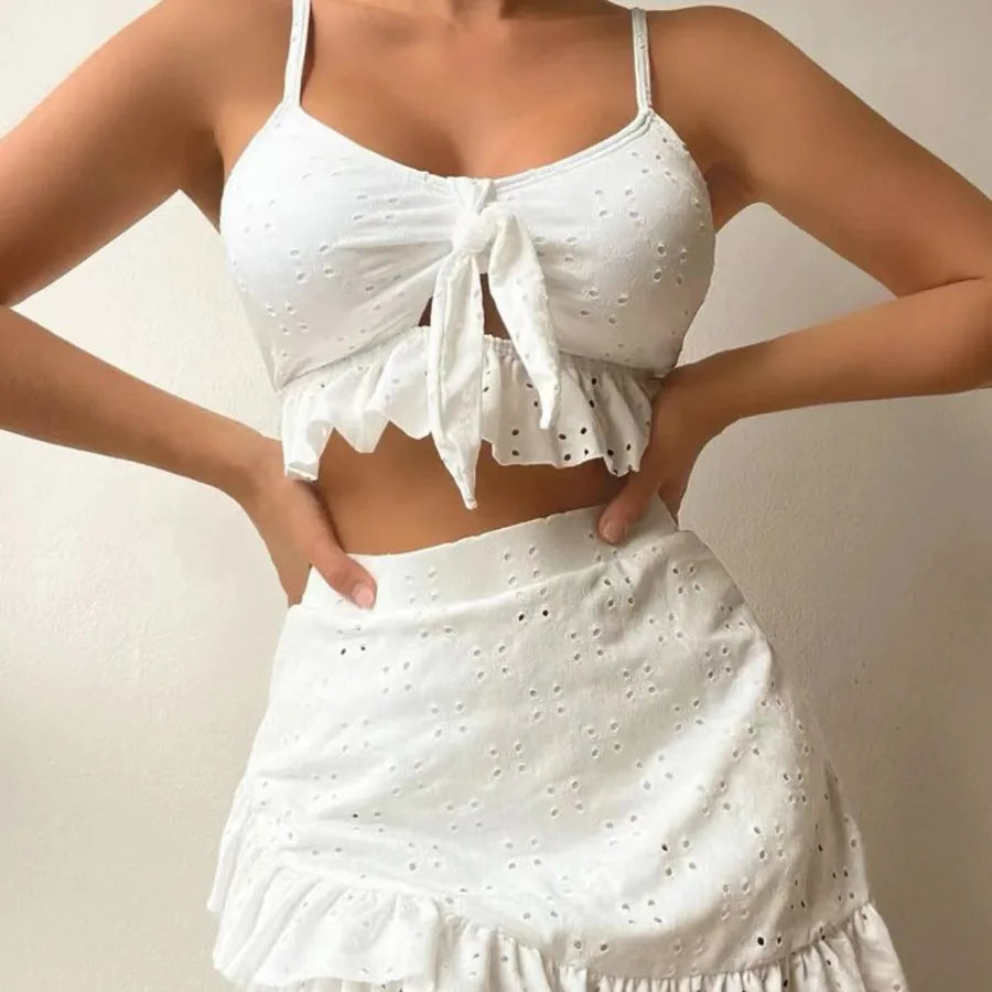 White eyelet top and skirt set on a plain background
