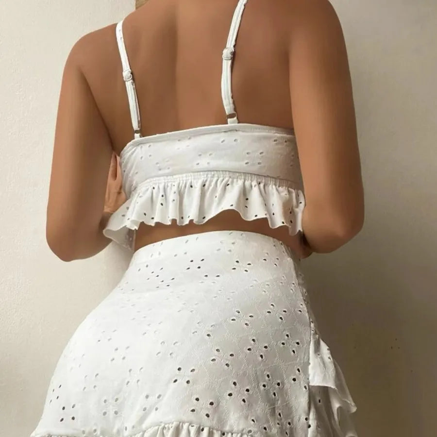 White eyelet top and skirt set on a neutral background