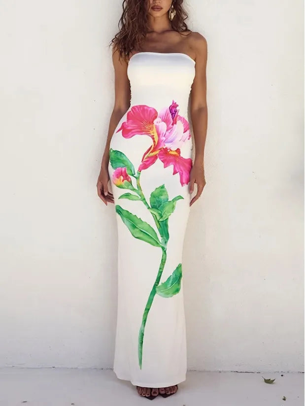 Woman wearing a strapless dress with floral design against a white background. Vacation resort dress