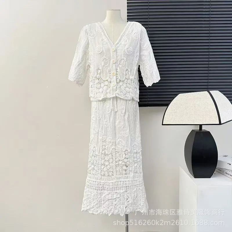 White lace dress on a mannequin against a neutral background