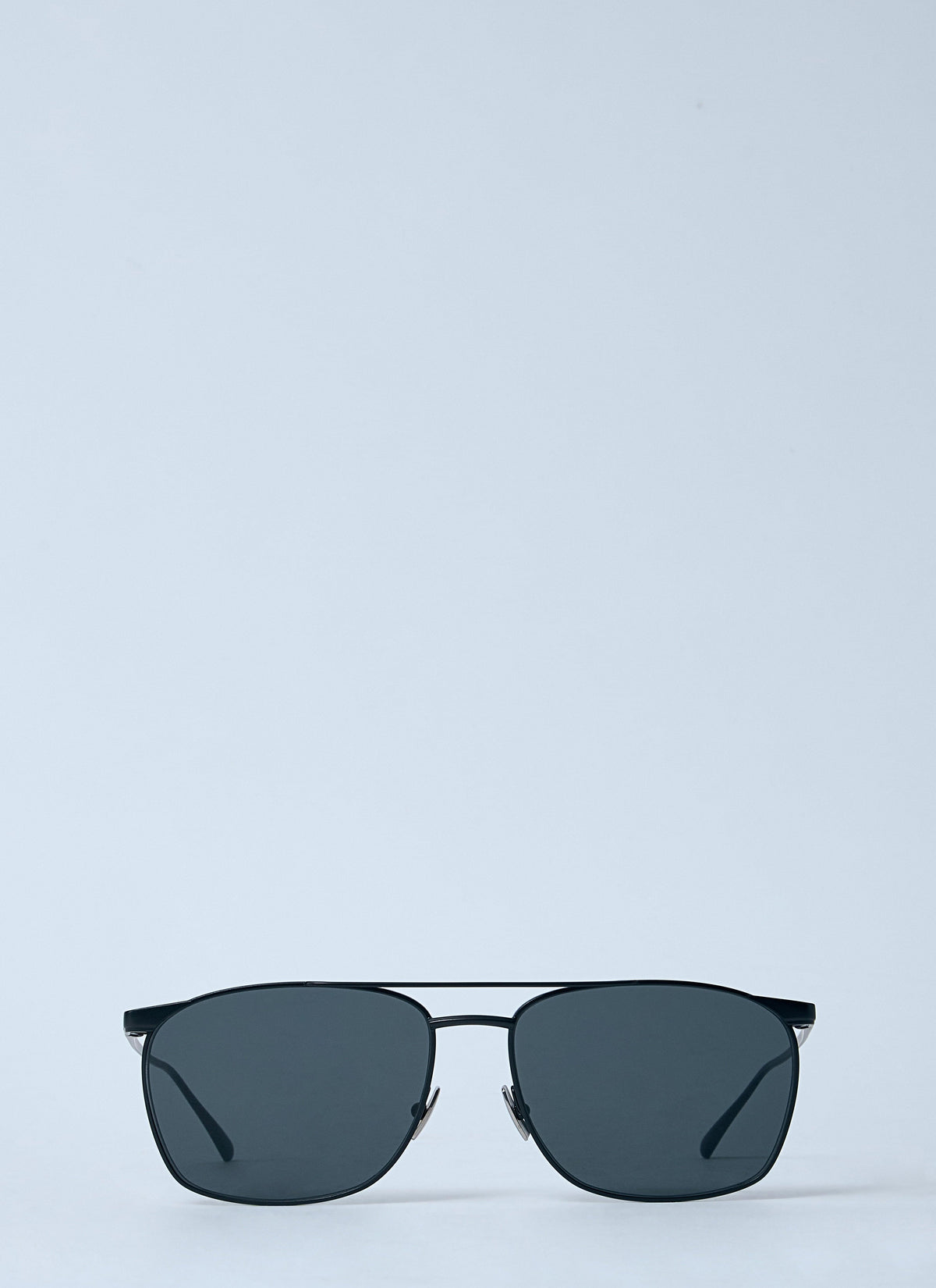 A pair of square aviator-style sunglasses with dark gray lenses and a thin black metal frame, positioned horizontally against a solid light gray background.