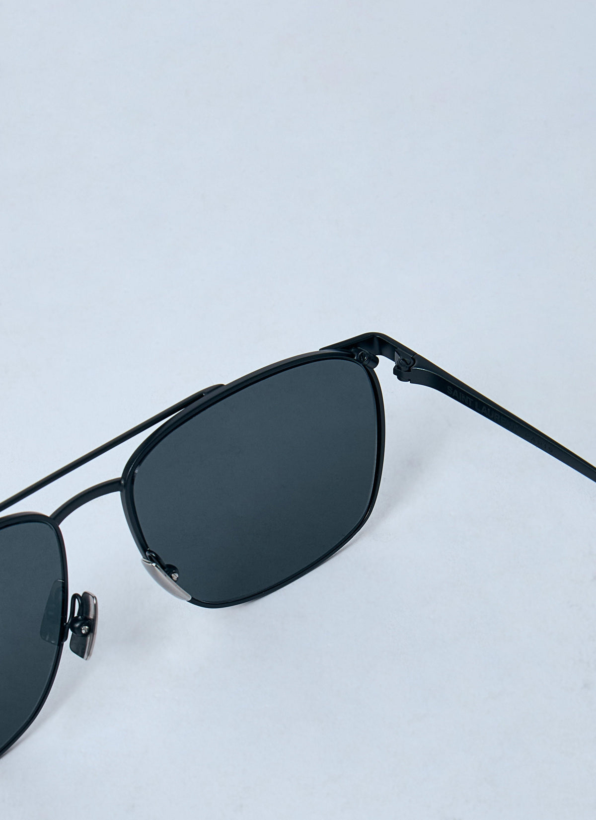 Black sunglasses on a light gray background